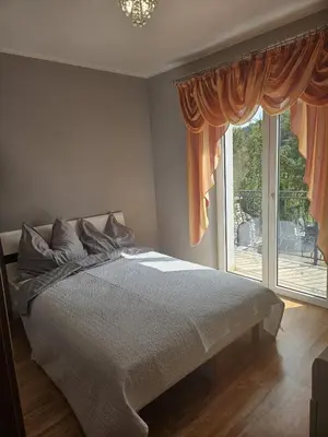 Łóżko lub łóżka w pokoju w obiekcie Willa na Ogrodowej