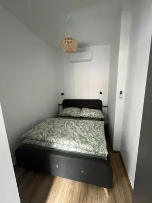 Łóżko lub łóżka w pokoju w obiekcie Apartament Szmaragd