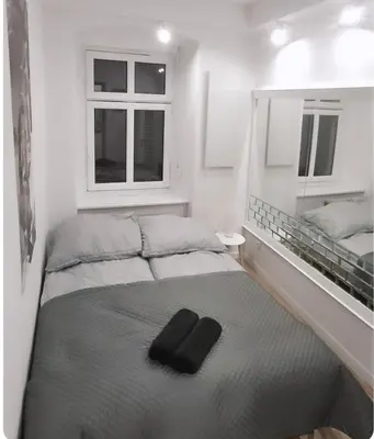 Łóżko lub łóżka w pokoju w obiekcie Apartament Antracyt