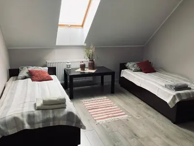 Łóżko lub łóżka w pokoju w obiekcie Kamienica pod Rakiem