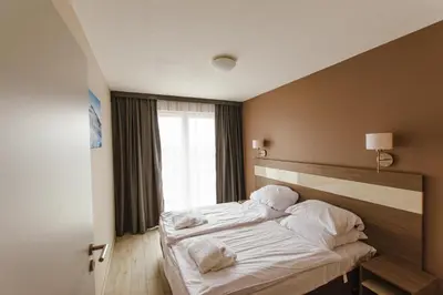 Łóżko lub łóżka w pokoju w obiekcie VacationClub - BORMIO Apartament 17