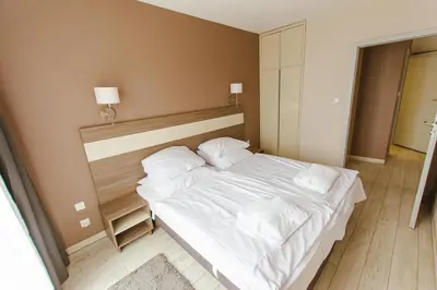 Łóżko lub łóżka w pokoju w obiekcie VacationClub - BORMIO Apartament 29