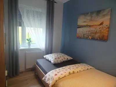 Łóżko lub łóżka w pokoju w obiekcie Apartament na Letniej