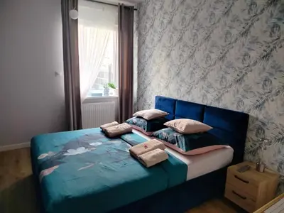 Łóżko lub łóżka w pokoju w obiekcie Apartament na Letniej