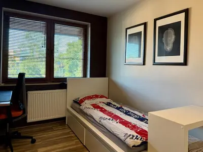 Łóżko lub łóżka w pokoju w obiekcie Apartament Zielona Przystań Wrocław