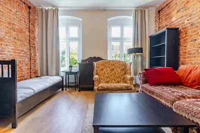 Łóżko lub łóżka w pokoju w obiekcie Gliwice Industrial Brick Style Apartment by BookingHost