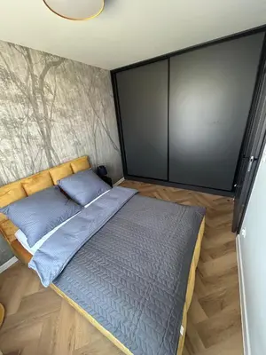 Łóżko lub łóżka w pokoju w obiekcie Apartament Grafitowy