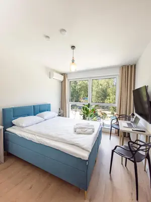 Łóżko lub łóżka w pokoju w obiekcie Lago Nysa Apartamenty nad Jeziorem Nyskim