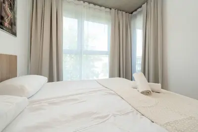 Łóżko lub łóżka w pokoju w obiekcie Księcia Witolda 60 Stylowy Apartament w Klimatycznym Budynku by Noclegi Renters