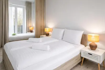 Łóżko lub łóżka w pokoju w obiekcie klimatyzowany Apartament nad Odra - Kurkowa 14 Centrum