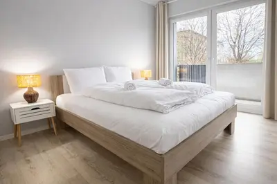 Łóżko lub łóżka w pokoju w obiekcie klimatyzowany Apartament nad Odra - Kurkowa 14 Centrum