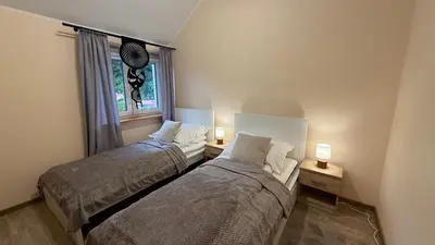 Łóżko lub łóżka w pokoju w obiekcie Jeleń Residence