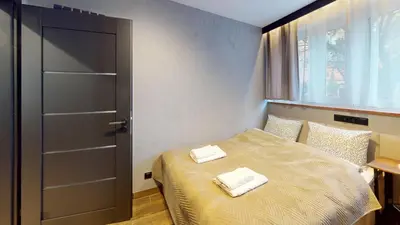 Łóżko lub łóżka w pokoju w obiekcie Tennis Family Lux Apartament City Center Nankiera 11