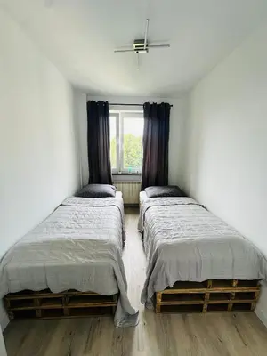 Łóżko lub łóżka w pokoju w obiekcie Apartament