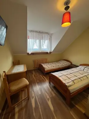Łóżko lub łóżka w pokoju w obiekcie Zajazd Oleńka