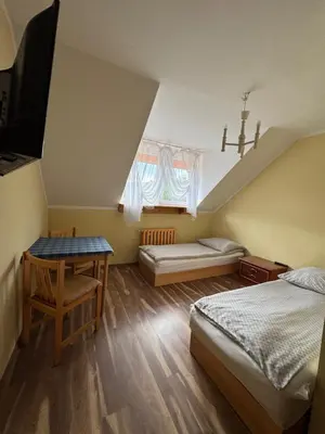 Łóżko lub łóżka w pokoju w obiekcie Zajazd Oleńka