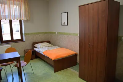Łóżko lub łóżka w pokoju w obiekcie Dom Wycieczkowy Odrodzenie