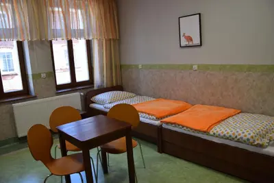 Łóżko lub łóżka w pokoju w obiekcie Dom Wycieczkowy Odrodzenie