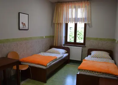 Łóżko lub łóżka w pokoju w obiekcie Dom Wycieczkowy Odrodzenie
