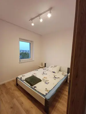 Łóżko lub łóżka w pokoju w obiekcie Mieszkania i Apartamenty