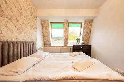 Łóżko lub łóżka w pokoju w obiekcie Vacation Club - Aleja Zwycięzców 3 Apartament 34