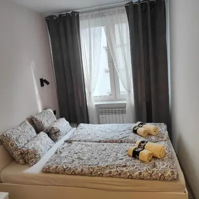 Łóżko lub łóżka w pokoju w obiekcie Apartament Krakowska