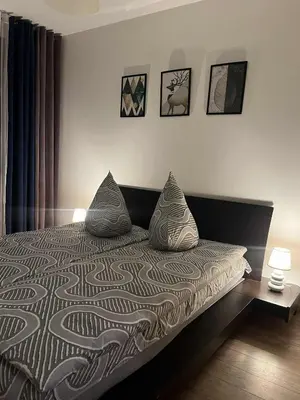 Łóżko lub łóżka w pokoju w obiekcie Apartament Enea z balkonem