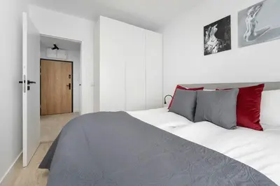 Łóżko lub łóżka w pokoju w obiekcie Stylish Apartment for 4 People with Underground Parking by Noclegi Renters