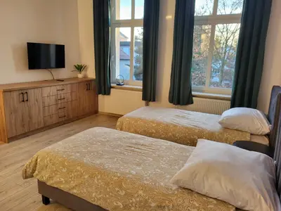 Łóżko lub łóżka w pokoju w obiekcie AS ELITE Apartament Kozielska parking