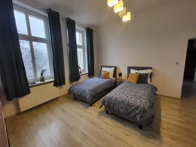 Łóżko lub łóżka w pokoju w obiekcie AS ELITE Apartament Kozielska parking