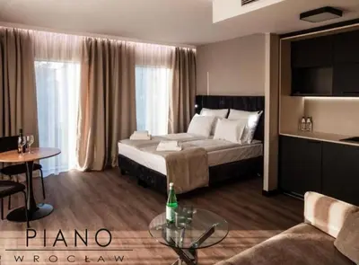 Łóżko lub łóżka w pokoju w obiekcie Piano Property Rental Wrocław