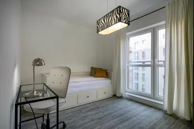 Łóżko lub łóżka w pokoju w obiekcie RentPlanet - Apartament Jedności Narodowej
