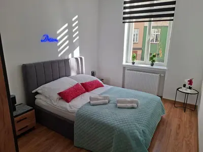 Łóżko lub łóżka w pokoju w obiekcie Apartament City Dream
