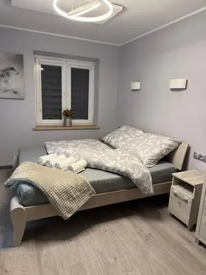 Łóżko lub łóżka w pokoju w obiekcie Apartament GreenHills 2