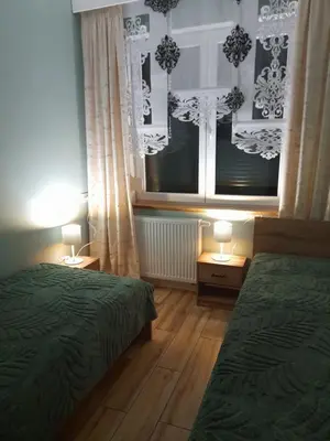 Łóżko lub łóżka w pokoju w obiekcie Apartamenty u Bodzia 3