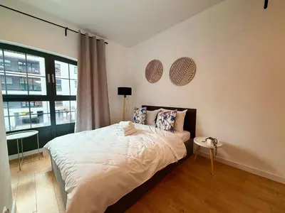Łóżko lub łóżka w pokoju w obiekcie Mieszczańska Riverfront Apartment by BookingHost