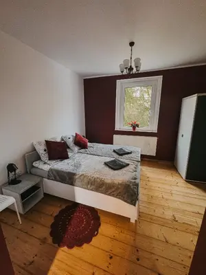 Łóżko lub łóżka w pokoju w obiekcie Szczytny Zakątek Apartamenty