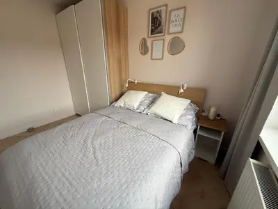 Łóżko lub łóżka w pokoju w obiekcie Apartament Przy Palmiarni