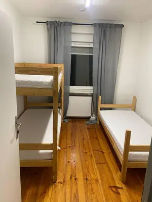 Łóżko lub łóżka w pokoju w obiekcie NOMAD Hostel