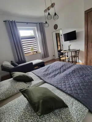 Łóżko lub łóżka w pokoju w obiekcie Apartament KB