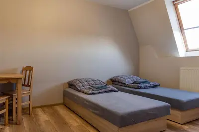 Łóżko lub łóżka w pokoju w obiekcie Noclegi GCK Biała