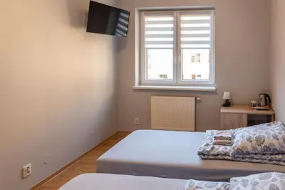 Łóżko lub łóżka w pokoju w obiekcie Noclegi GCK Biała