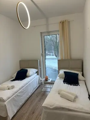 Łóżko lub łóżka w pokoju w obiekcie Apartament Grafitowy