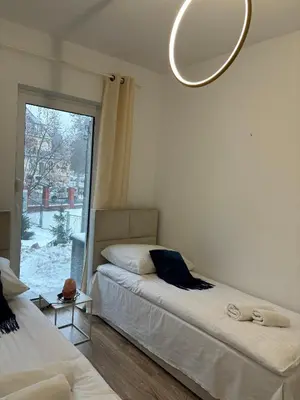 Łóżko lub łóżka w pokoju w obiekcie Apartament Grafitowy