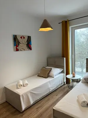 Łóżko lub łóżka w pokoju w obiekcie Apartament Bursztynowy