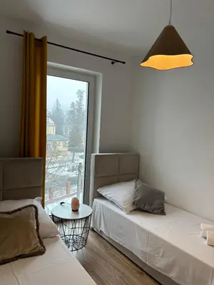 Łóżko lub łóżka w pokoju w obiekcie Apartament Bursztynowy