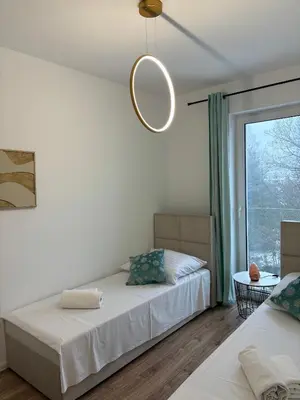 Łóżko lub łóżka w pokoju w obiekcie Apartament Morski