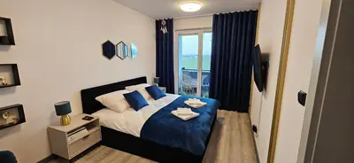 Łóżko lub łóżka w pokoju w obiekcie Apartament na Letniej EWA