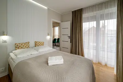 Łóżko lub łóżka w pokoju w obiekcie RentPlanet - Apartament Jedności Narodowej II