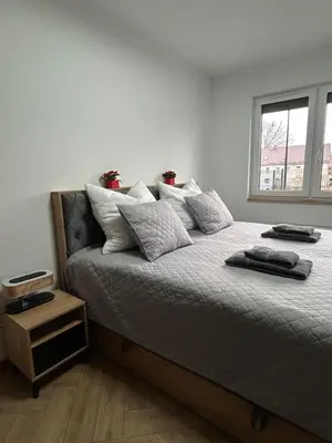 Łóżko lub łóżka w pokoju w obiekcie Apartament Bond